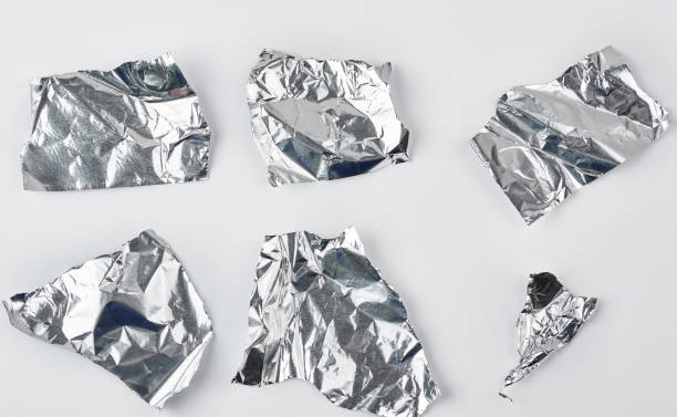 istock various pieces of silver  foil on a white background 1156831501