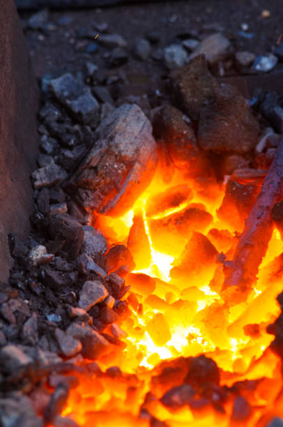 istock blacksmith furnace with burning coals, tools, and glowing hot metal workpieces 1156833260