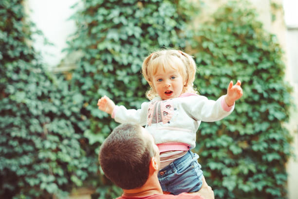 istock dad picks up the child 1156839869