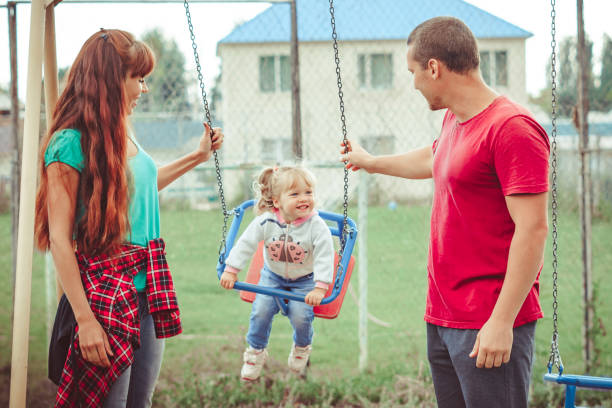 istock a child swinging on a swing 1156839929