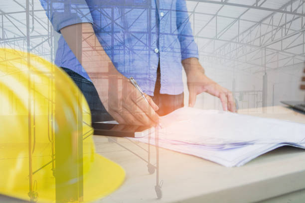 istock Double exposure of man working of architect sketching a construction project 1156839952