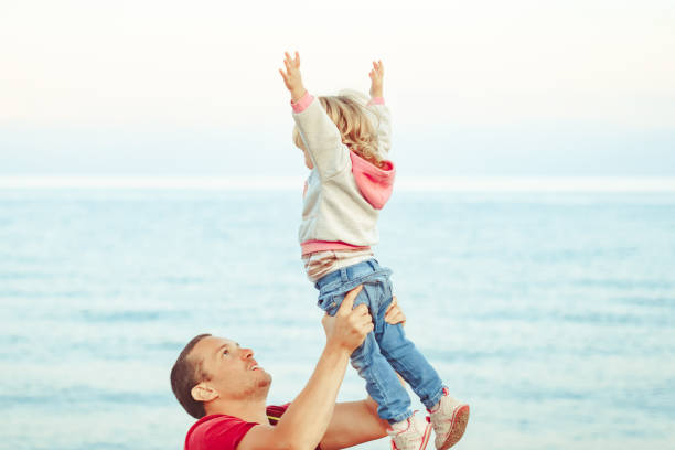 istock dad picks up the child 1156840056