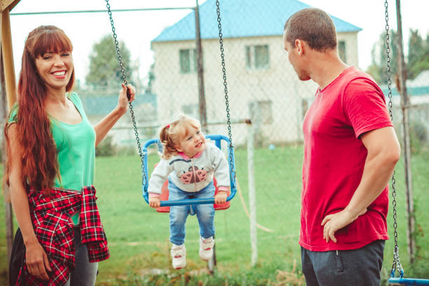 istock a child swinging on a swing 1156840850