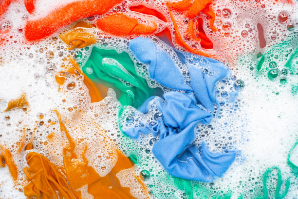 istock Color clothes soak before washing. 1156843365