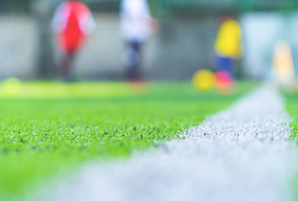 istock Soccer Academy field for children training blurred for background 1156843476