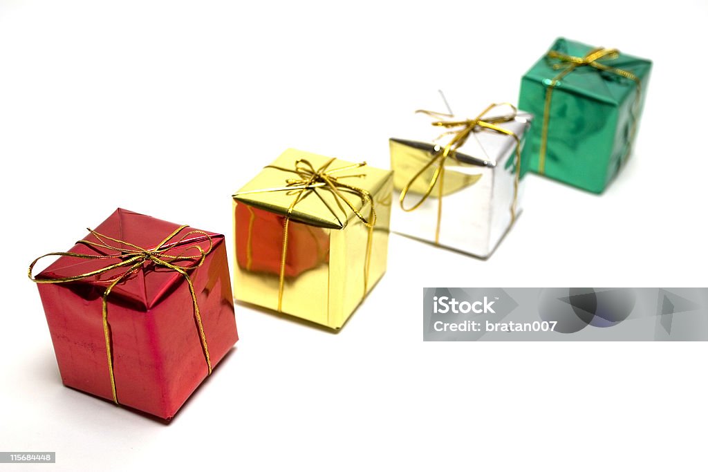 Presents in line Four little gift boxes in a row isolated Birthday Stock Photo