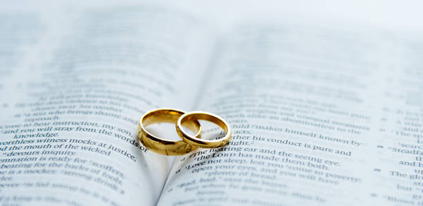 Wedding rings on open bible Wedding rings on open bible. honeymoon book stock pictures, royalty-free photos & images