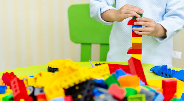 Little boy playing with colorful toy block.