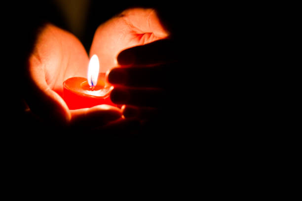 istock Woman hands holding candle light 1156845117