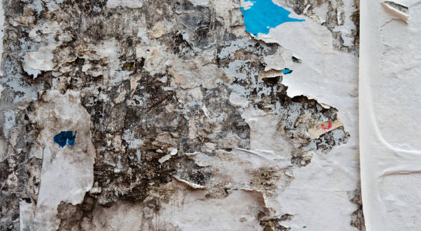 istock Wall covered with posters ripped for background 1156845288