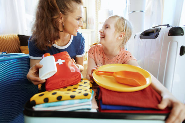 istock mother and child with open suitcase suitcase ready for resort 1156845946