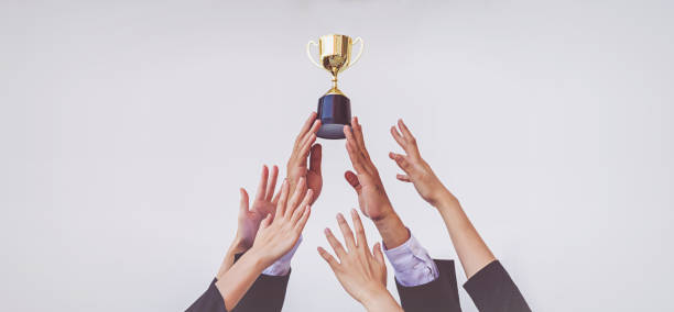 Hands scramble for the golden trophy cup, concept business Hands scramble for the golden trophy cup, concept business office competition stock pictures, royalty-free photos & images