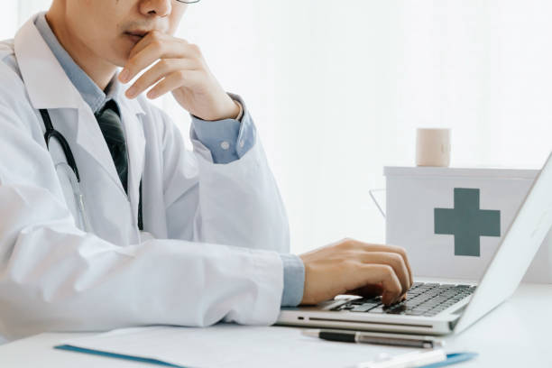 istock Male doctor use computer,research and analyze,Disease analysis,and record patient information,Concept using technology for medical benefits and data collection 1156852997