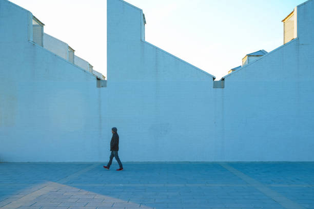 A man browsing at a secondhand book stall near the National Theatre on London’s South Bank on a sunny spring day. During the COVID-19 pandemic, very few people are to be seen.