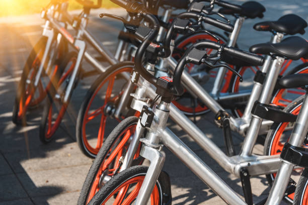 istock row of sharing bicycles parked on sidewalk 1156856585