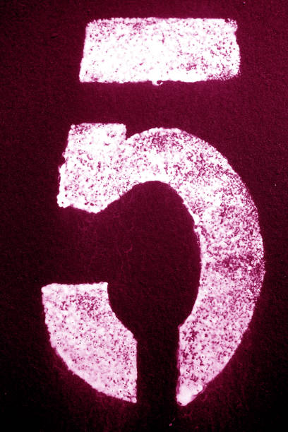 istock Number 5 in stencil on metal wall in pink tone. 1156863729
