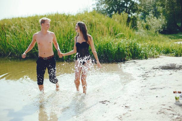 istock Elegant couple having fun in a river 1156864275