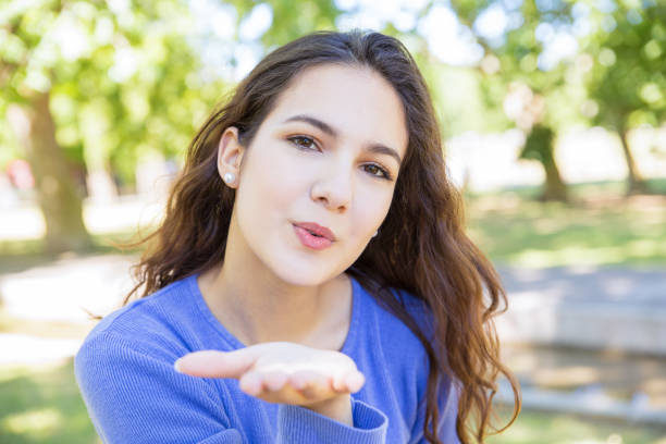 istock Charming young woman blowing air kiss 1156865577