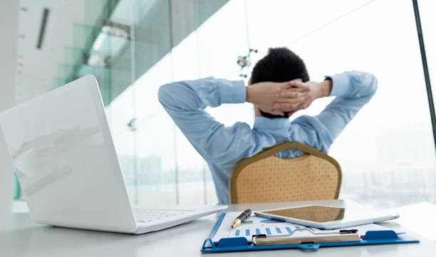 istock Relaxed Businessman lening back in office 1156866506
