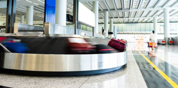istock Luggages moving on airport conveyor belt 1156866807