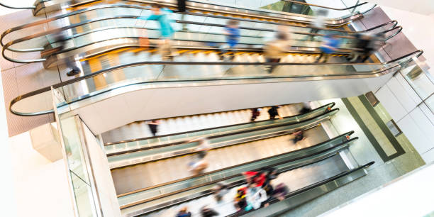 istock People in motion in escalators at the modern shopping mall 1156866843