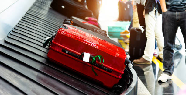 istock Luggages moving on airport conveyor belt 1156866931