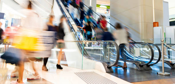 istock Crowed people in blurred motion on escalator 1156867152