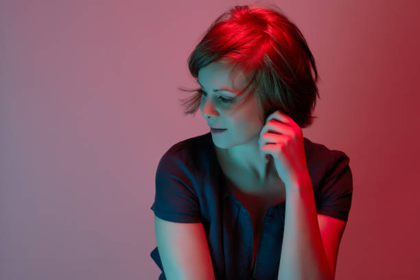 istock Beautiful attractive young woman posing in neon light in studio 1156867230