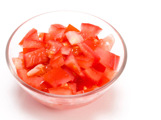 istock Sliced tomato in a transparent bowl on white background 1156867790