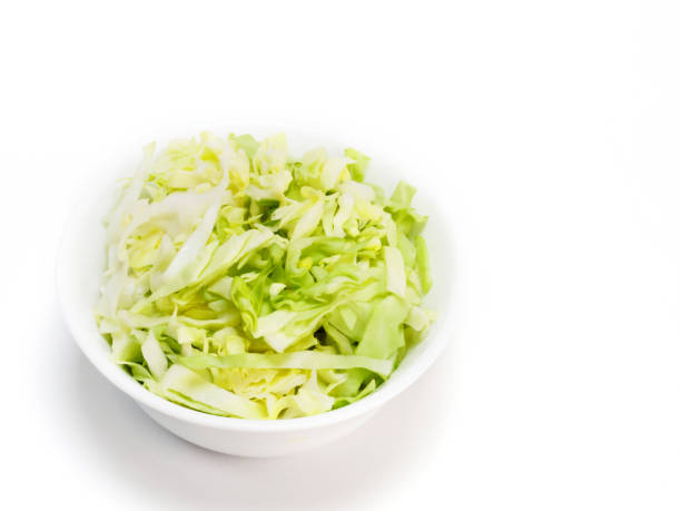 istock Chopped green cabbage in white bowl on a white background with copy space 1156868430