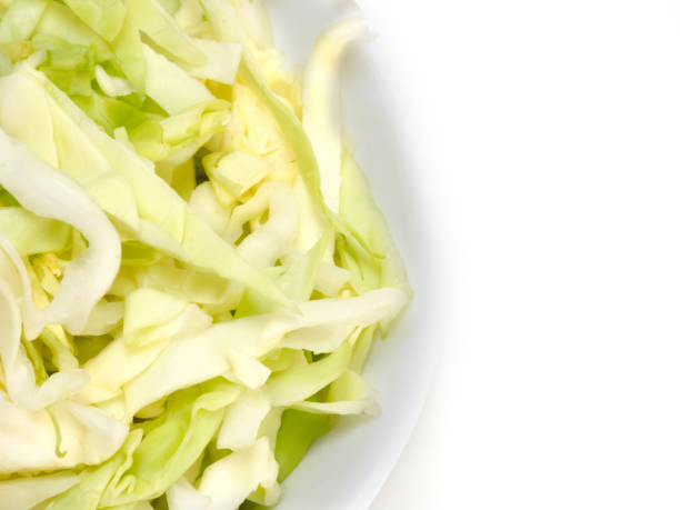 istock Chopped green cabbage in half white bowl on a white background with copy space 1156868481