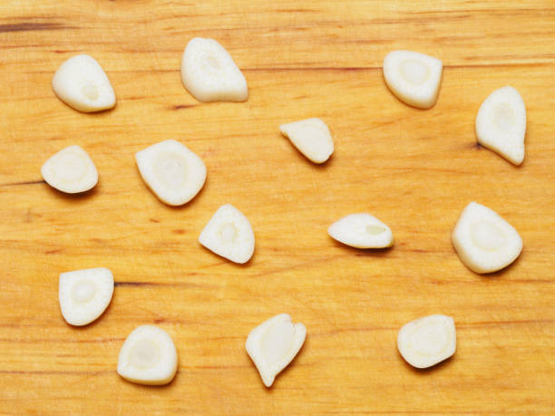 istock Chopped garlic on wooden background 1156869188