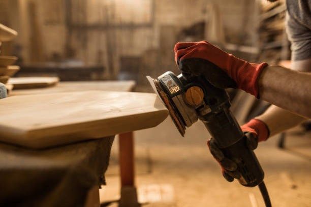 istock Close-up of carpenter using sander while working on piece of wood. 1156870243