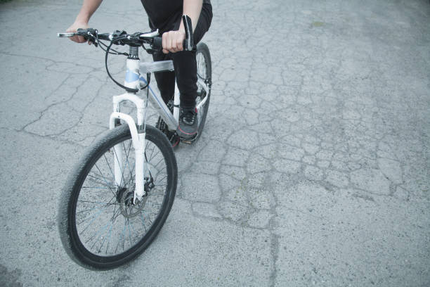 istock Caucasian boy riding bicycle at asphalt. 1156871626
