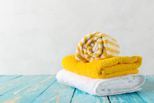 istock Stack of bath towels on wooden table with copy space 1156872374