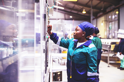 Africa, Industries, Business, Factory - A Female African Production Line Operator at Work