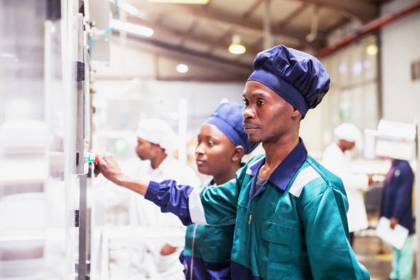 istock Dairy factory workers operating an advance industrial machinery 1156873365