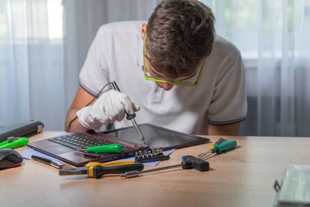 Young engineer soldering microcircuit. Renovation in repair shop, close-up Young engineer soldering microcircuit. Renovation in repair shop, close-up installing laptop ram stock pictures, royalty-free photos & images