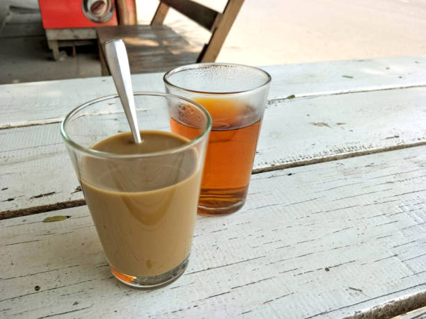 istock Hot coffee served with hot tea On a white wooden table. 1156873513