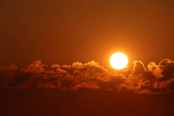 istock Sunset with clouds, setting shining sun and orange sky 1156874747