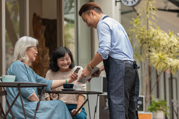 istock Two senior ladies using contactless payment 1156874758