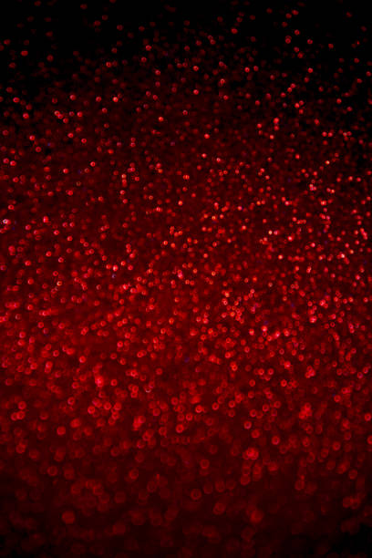 istock Abstract red glitter confetti sparkles on black background. 1156874825