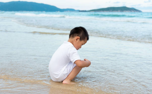 Asian boy have fun on the beach.