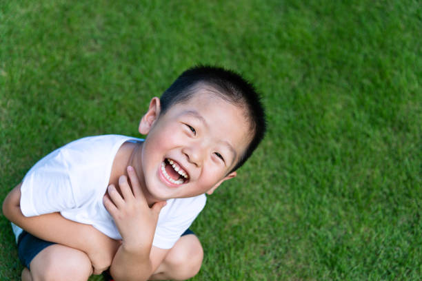 POV of cute little girl that runs to dad hug in the green grass backyard.