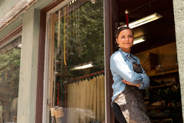 istock Young female entrepreneur working at her small workshop business 1156875781