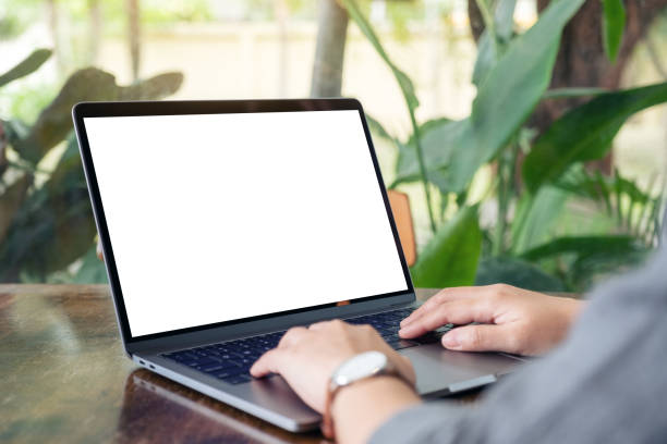 istock a woman using and typing on laptop with blank white desktop screen 1156876254
