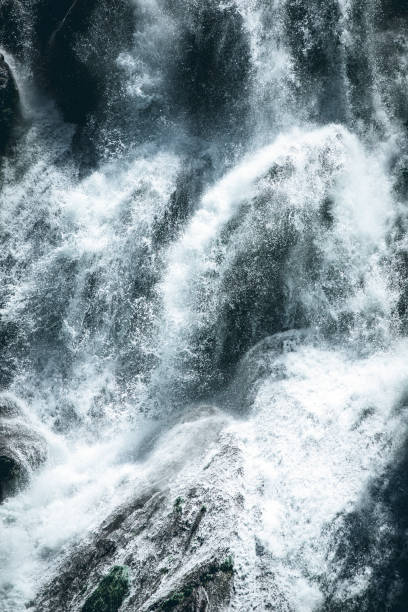 istock power of a waterfall water - dark mood style image 1156876301