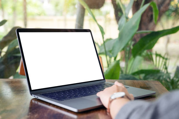 istock a woman using and touching laptop touchpad with blank white desktop screen 1156876346
