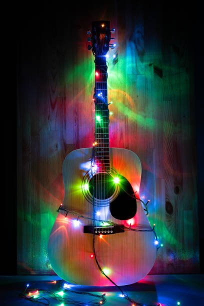 istock Classic Acoustic Guitar in christmas lights 1156876481