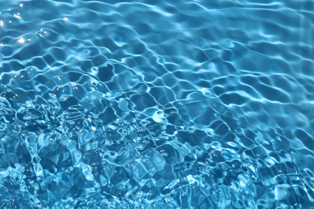 istock Blue and bright water surface with sun refection in swimming pool for background 1156877454